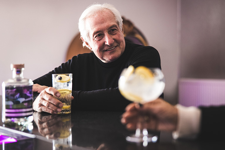 Sir Gareth Edwards CBE drinking gin at a bar