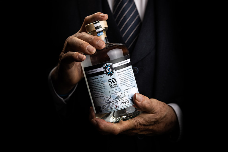 Sir Gareth Edwards CBE holding bottle